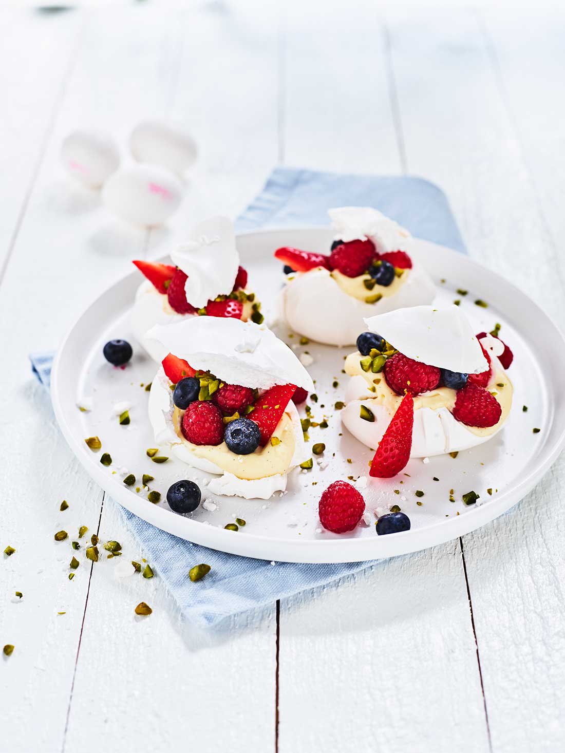 Pavlova med färska bär, vaniljkräm och pistage